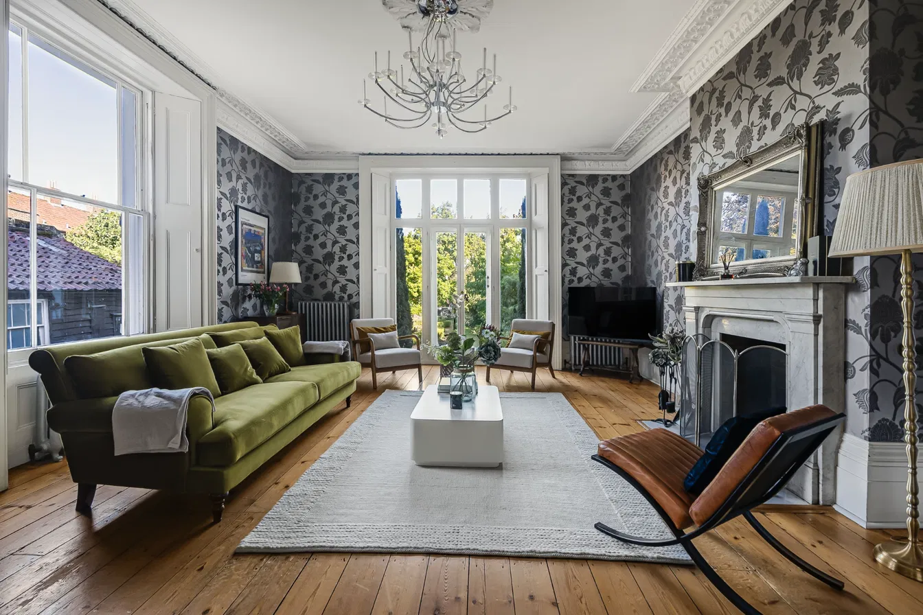 Reception room with marble fireplace inside a Hostahome-managed property in Hertford