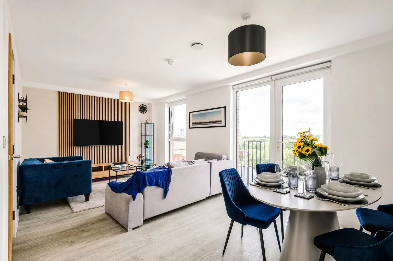 Guest-ready open-plan apartment with dining and living areas.