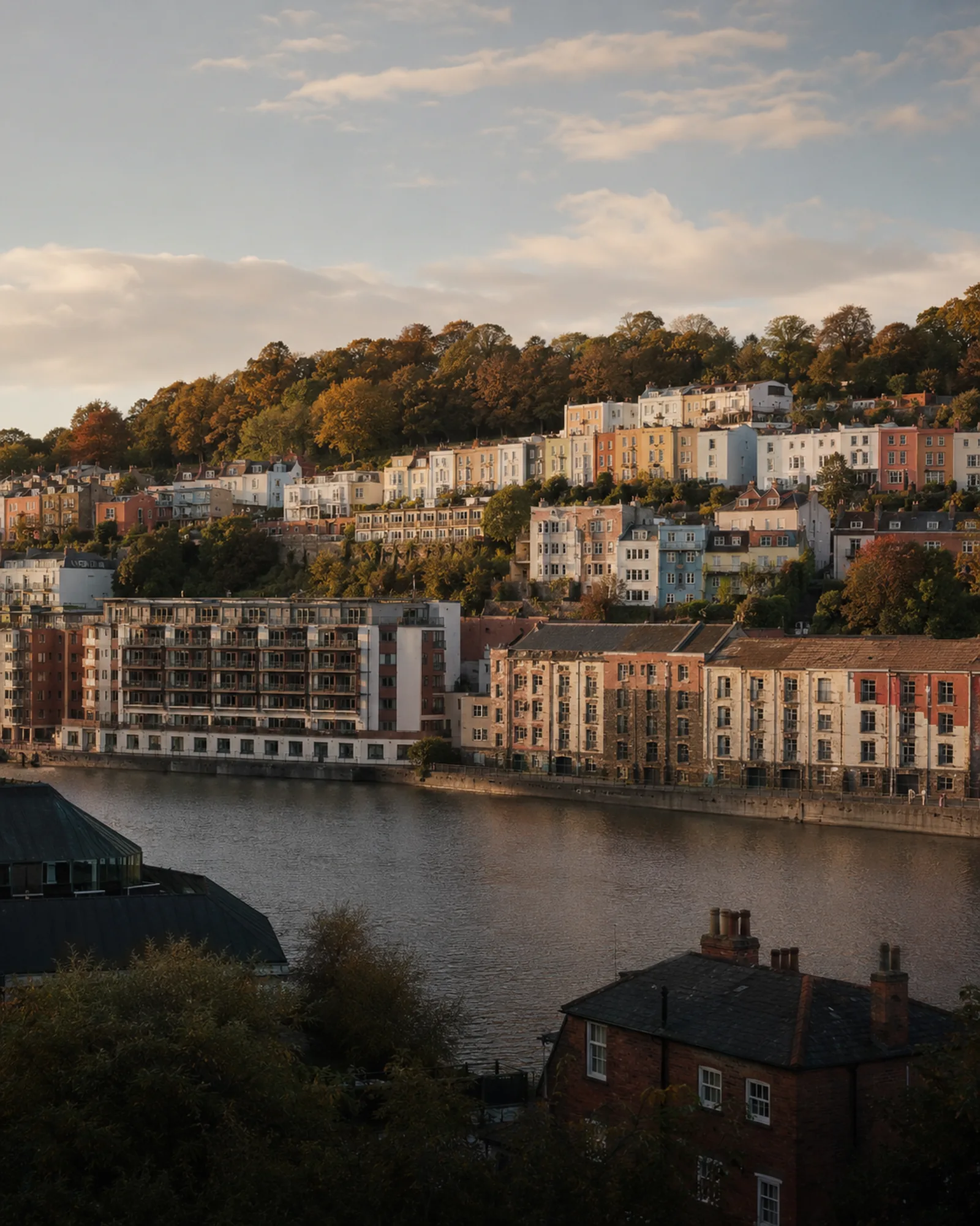 Bristol's Cliftonwood pastel terraces on the hillside above the harbour at golden hour.